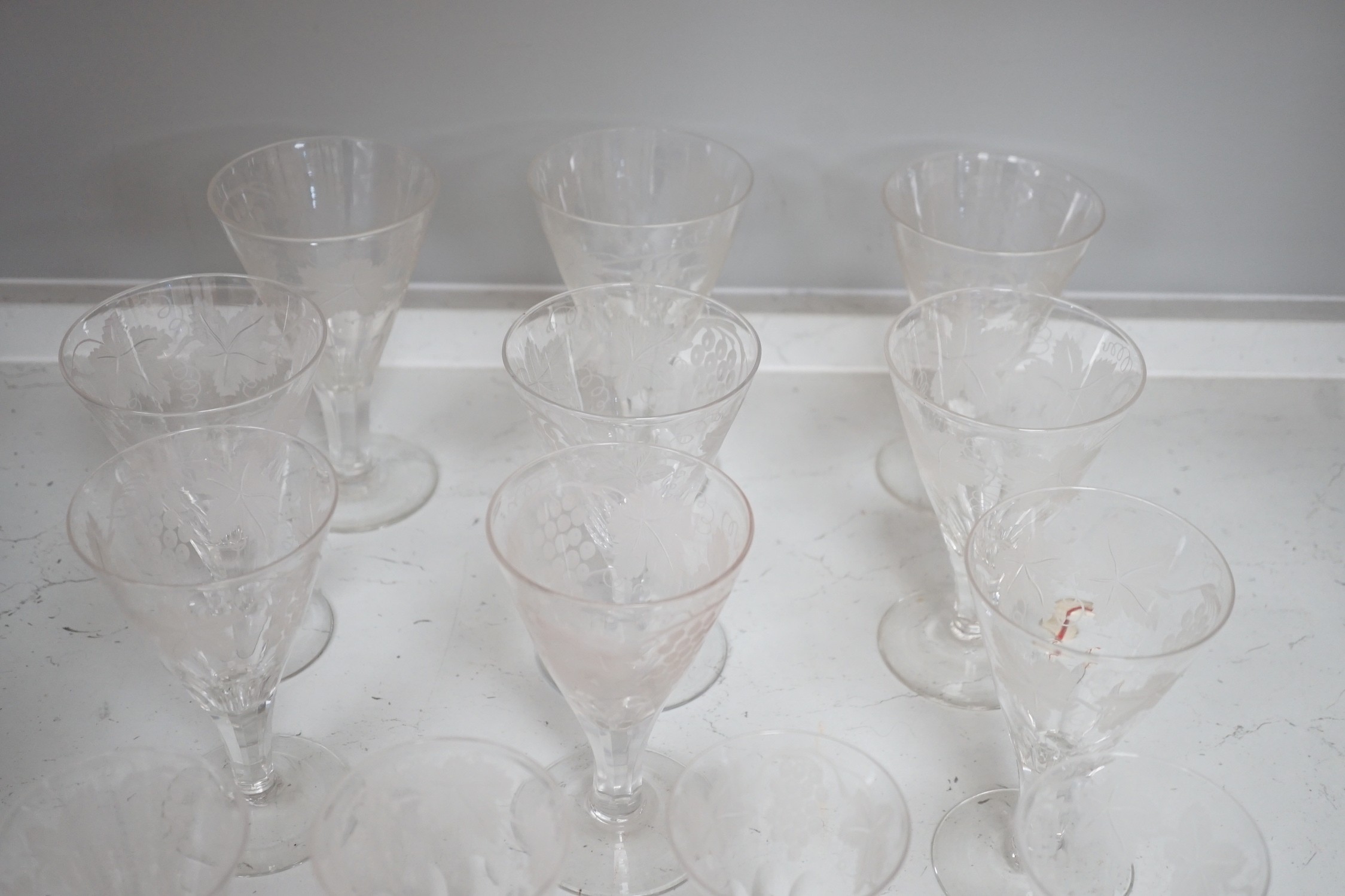 A part suite of Edwardian vineous etched glasses, tallest 15cm. Condition - one with splinter chip to central underside base, otherwise good